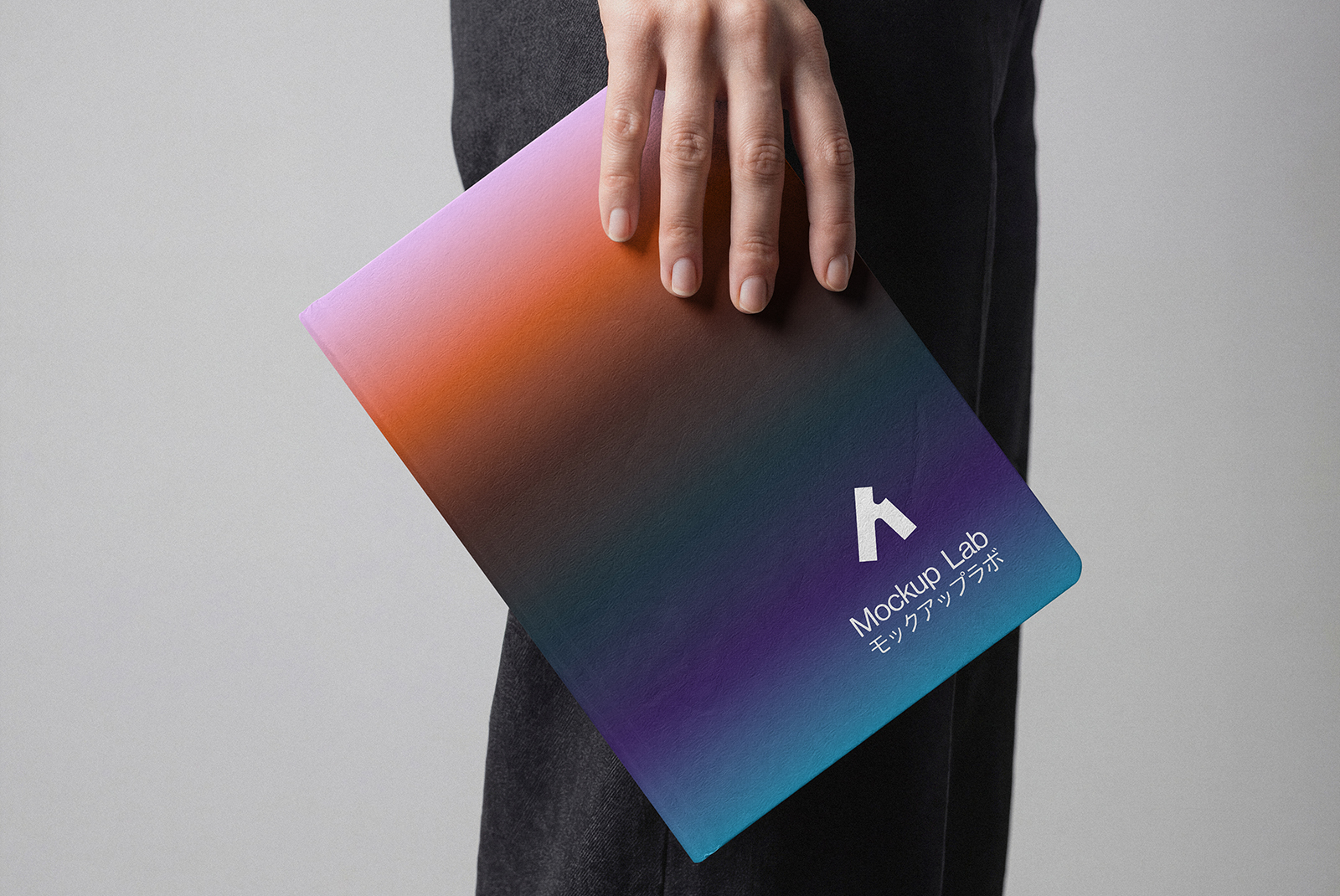 Angled shot of the notebook mockup, highlighting the cover and an interior page design.